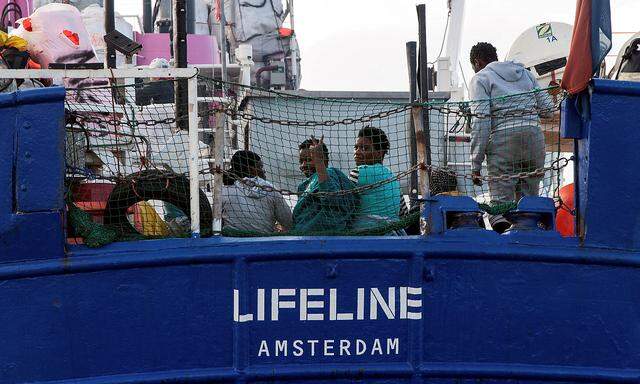Migrants are seen on the deck of  Mission Lifeline rescue boat  in the central Mediterranean Sea