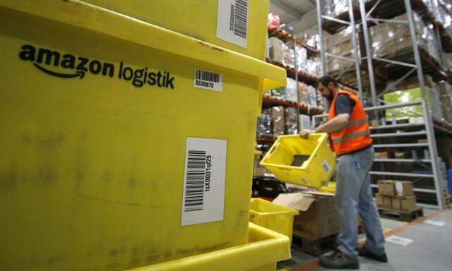 A worker sorts packages at the Amazon warehouse in Leipzig