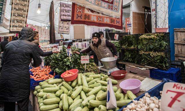February 25 2018 Istanbul Turkey A man selling vegetables in Tarlabasi Sunday market in Istanb