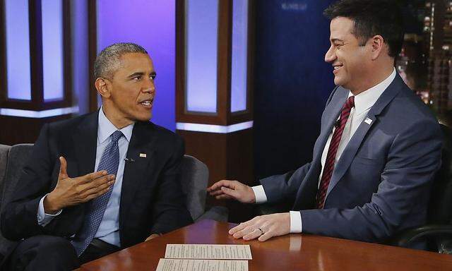 Obama talks with show host Jimmy Kimmel during a commercial break in a taping of Jimmy Kimmel Live in Los Angeles