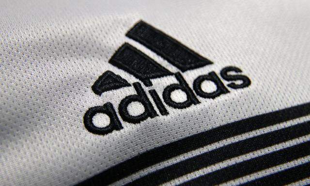 FILE PHOTO: An Adidas sign is seen before the company's annual news conference in Herzogenaurach