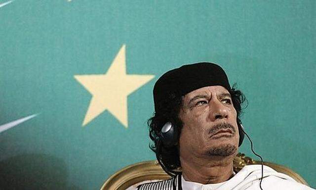 File photo of Libyan leader Muammar Gaddafi looking on as Italys Prime Minister Silvio Berlusconi gis Prime Minister Silvio Berlusconi gi