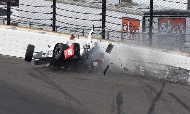 Indy Car driver Sebastien Bourdais slams the turn 2 wall during qualifications at the Indianapolis M