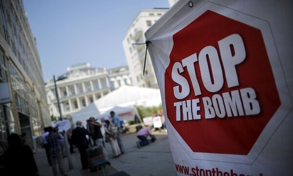 A sign which reads 'Stop the Bomb' is seen as protesters gather outside the hotel where the Iran nuclear talks meetings are being held in Vienna, Austria