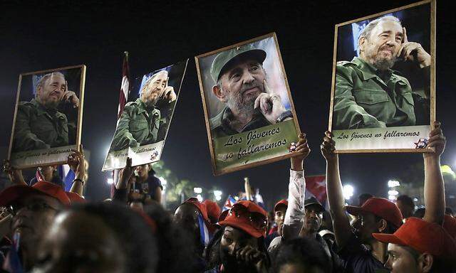 People cheer at a tribute to former Cuban leader Fidel Castro in Santiago de Cuba