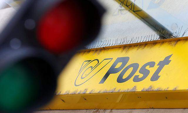A File photo of the Austrian Post logo behind traffic lights at a post office in Vienna