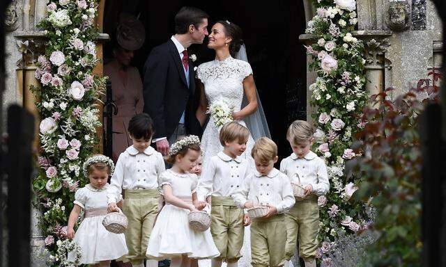 Pippa Middleton kisses her new husband James Matthews, following their wedding ceremony at St Mark's Church in Englefield