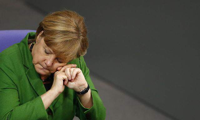 German Chancellor Merkel listens to a debate about NSA surveillance during Bundestag session in Berlin