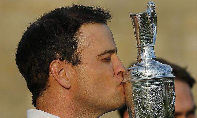 Johnson of the U.S. celebrates as he kisses the Claret Jug after winning the British Open golf championship on the Old Course in St. Andrews, Scotland