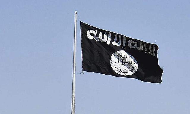 Vehicles drive past a flag of the al-Qaeda linked Islamic State of Iraq and the Levant, at the entrance to Raqqa