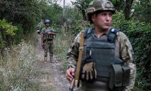Ukrainian servicemen are seen at their positions on the front line near Avdeyevka
