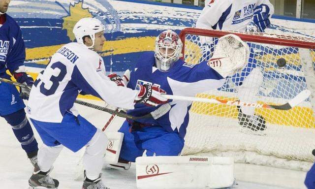 Goalie Jonas Gustavsson deflects a puck off the stick of David Clarkson in a NHLPA charity hockey game in Toronto
