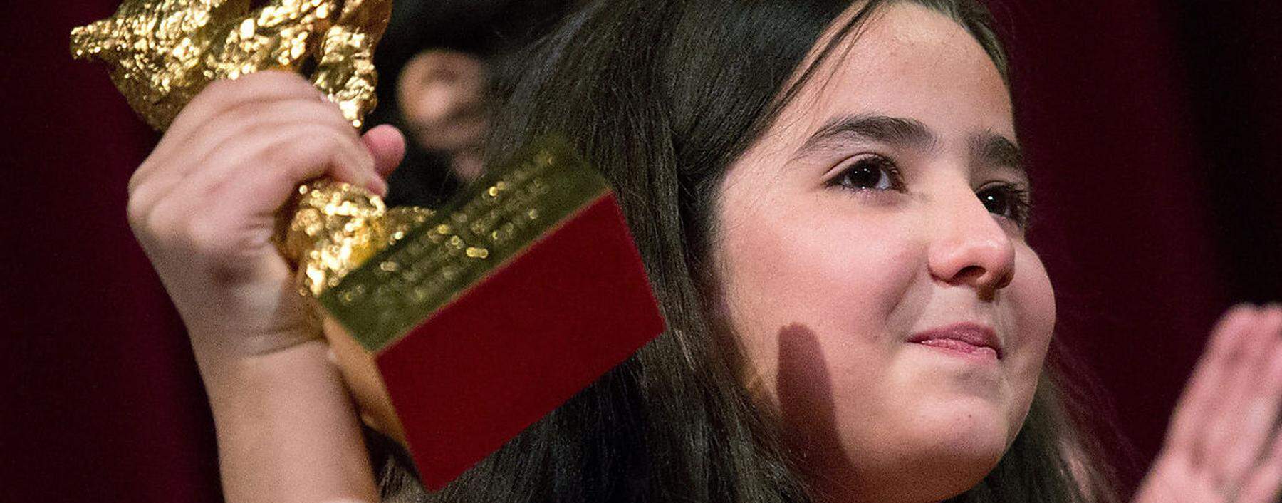 The niece of Iranian film director Panahi accepts the Golden Bear for Best Film on her uncle's behalf during awards ceremony at 65th Berlinale International Film Festival in Berlin