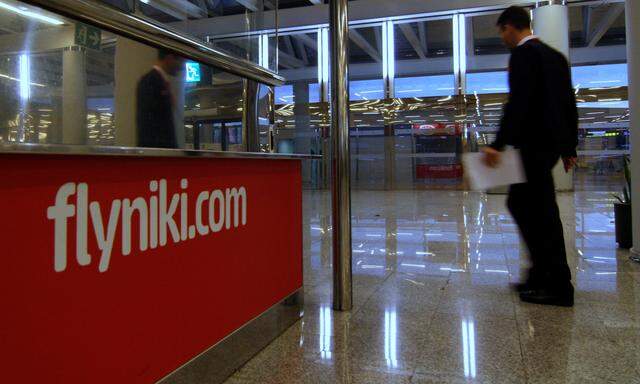 A man walks past an empty Niki customer care desk at Palma de Mallorca airport