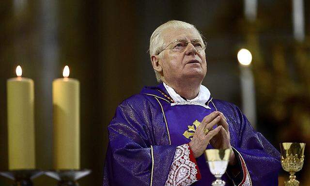 Cardinal Angelo Scola of Italy prays as he gives mass at the Santi XII Apostoli in Rome