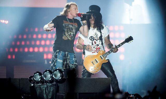 Axl Rose, lead singer of American rock band Guns N' Roses, performs with Slash at Parken Stadium in Copenhagen