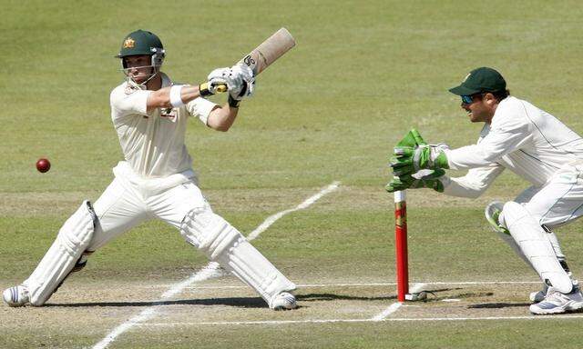 File photo of Australia's Phil Hughes playing a shot next to South Africa's Mark Boucher during the third day of the second cricket test match in Durban