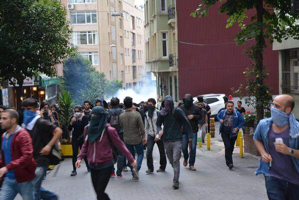 Unter den Demonstranten herrschte nicht immer Einigkeit. Als einige Vermummte im Stadtteil Cihangir ein Supermarkt zerstörten, kam es zu einem Streit mit den anderen Demonstranten, die die Zerstörung verurteilten. Auch bei der Neuauflage der Gezi-Proteste handelt es sich nicht um eine homogene Gruppe: Anarchisten, Gewerkschaften, Oppositionsparteien, Studenten, Schwul-lesbische Gruppen usw. haben zur Demonstration aufgerufen. Im Bild: Demonstranten rennen vor den Tränengasschwaden weg.