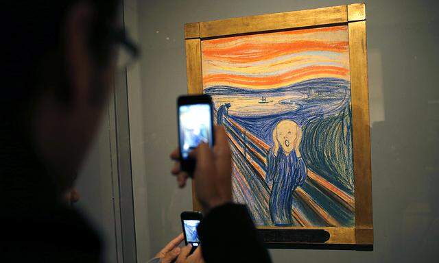 People use camera phones to photograph Edvard Munch´s iconic ´The Scream´, a pastel-on-board (1895) during a press preview of an exhibition of Munch´s work at New York City´s Museum of Modern Art
