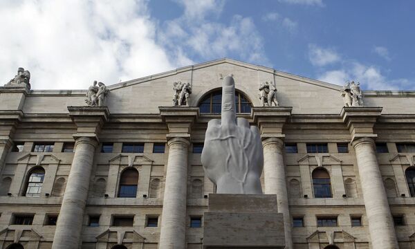 A sculpture called ' crippled hand' from Italian sculptor Maurizio Cattelan is placed in front of stock exchange palace in Milan