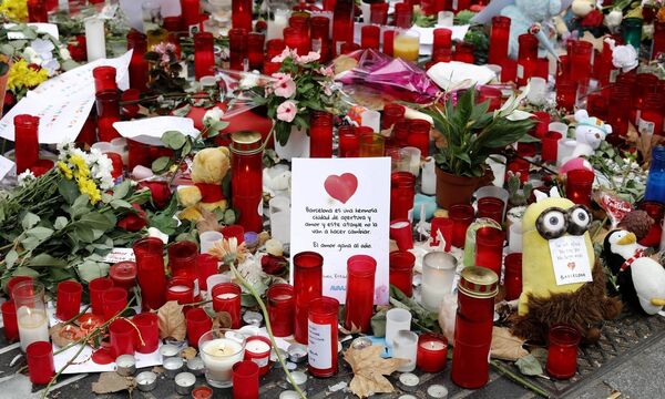 People pay their respect to the victims outside the Liceu Theatre on the site of a deadly van attac