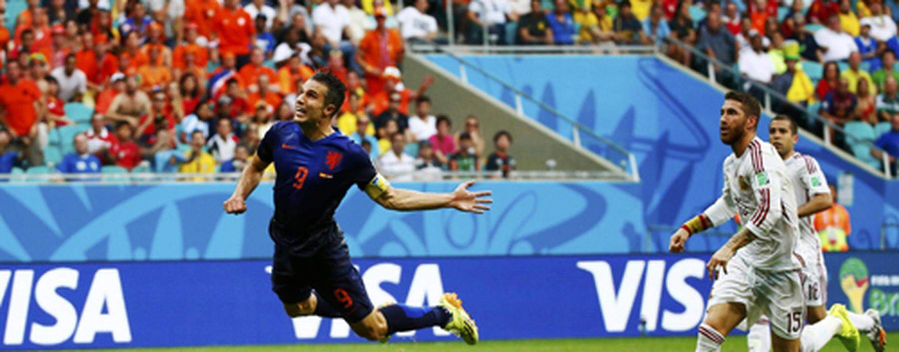 Robin van Persie of the Netherlands heads the ball to score against Spain during their 2014 World Cup Group B soccer match at the Fonte Nova arena in Salvador