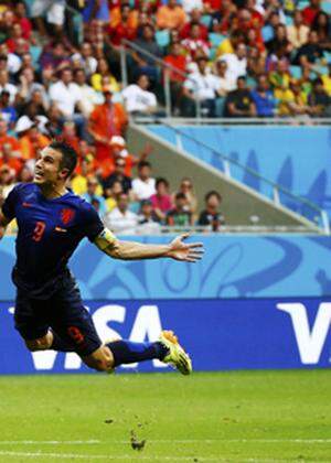 Robin van Persie of the Netherlands heads the ball to score against Spain during their 2014 World Cup Group B soccer match at the Fonte Nova arena in Salvador