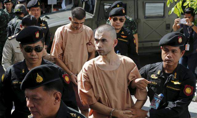 Suspect of Bangkok blast are escorted by soldiers and prison officers as they arrive at military court in Bangkok