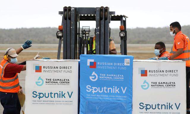 FILE PHOTO: Workers look at the shipment of Russia's Sputnik V vaccine at the airport, in Caracas