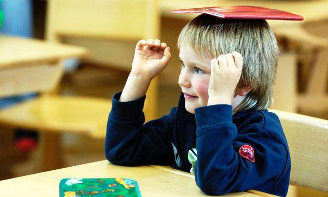 Junge mit Heft am Kopf - boy with a book on the head