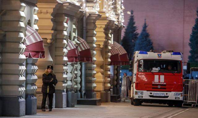 Security personnel are seen near GUM department store after bomb threats in Moscow