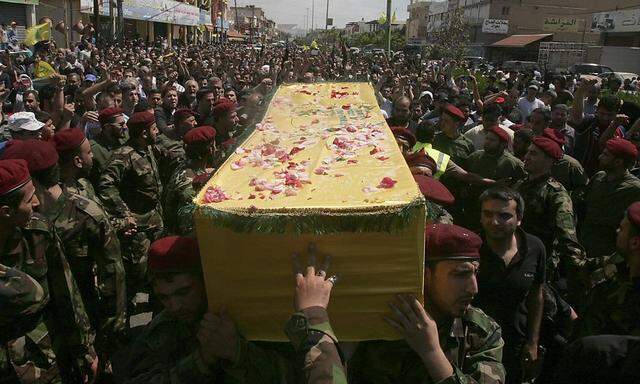 Supporters of Hezbollah and relatives of Hezbollah members attend the funeral of a Hezbollah fighter who died in the Syrian conflict, in Ouzai in Beirut