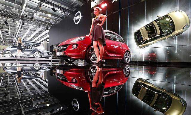A model stands next to an Opel Adam S car during the Moscow International Automobile Salon in Krasnogorsk outside Moscow