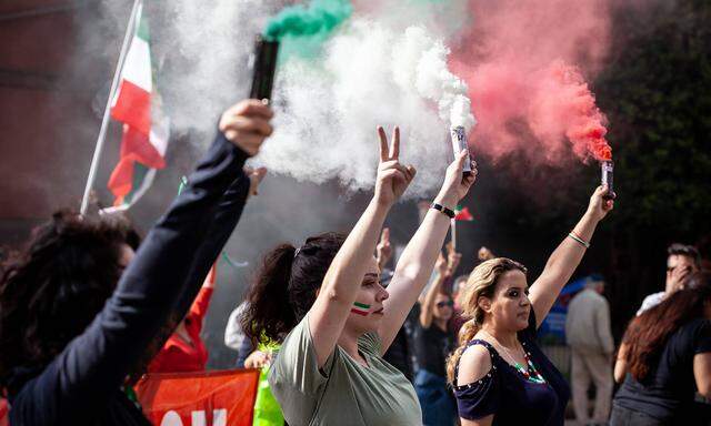 Protest vote against the Islamic Republic in Iran Demonstrators release smoke in the colors of the Iranian flag during a