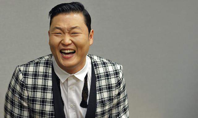 File photo of South Korean singer Psy smiling as he attends a meeting with U.N. Secretary-General Ban during a photo opportunity at U.N. headquarters in New York