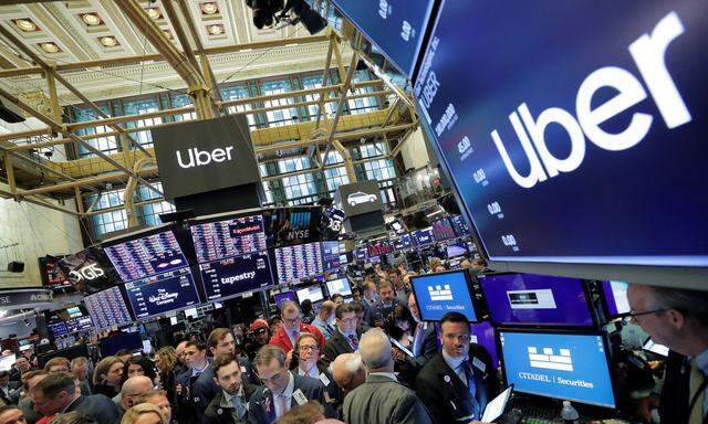 Traders gather at post where Uber Technologies Inc. holds IPO on floor of NYSE in New York