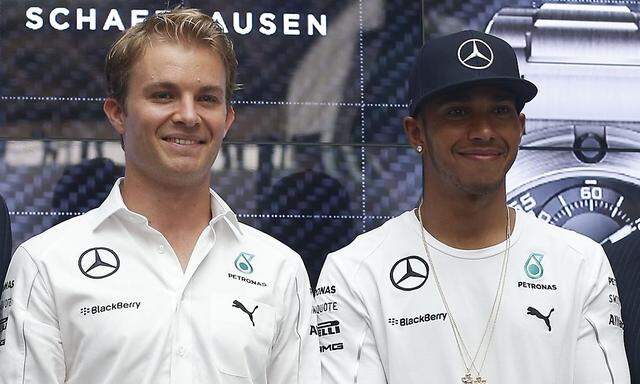 Mercedes Formula One drivers Nico Rosberg of Germany and Lewis Hamilton of Britain attend a publicity event to unveil watches that they co-designed in Singapore