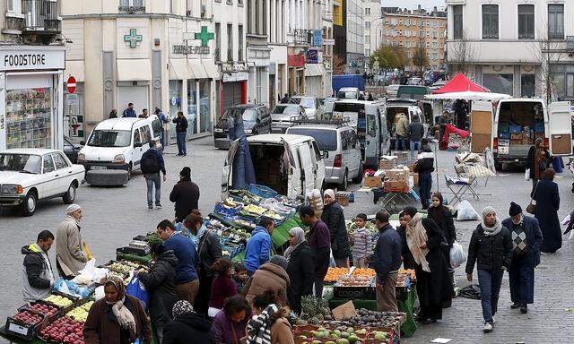 People shop at a market in the neighbourhood of Molenbeek in Brussels, Belgium