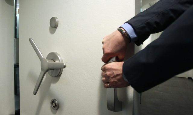 Employee closes a safe door inside an Austrian bank in Vienna