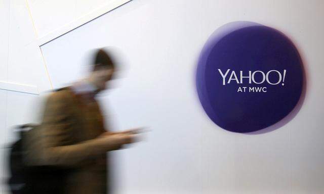 File photo of a man walking past a Yahoo logo during the Mobile World Congress in Barcelona