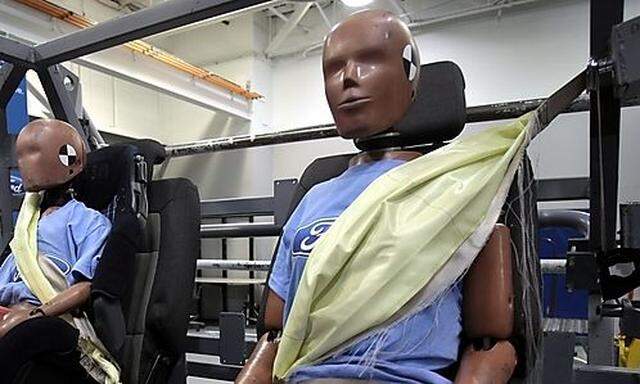 Crash test dummies wear seat belt air bags at the Ford Motor Co. Safety Innovation Laboratory in Dear