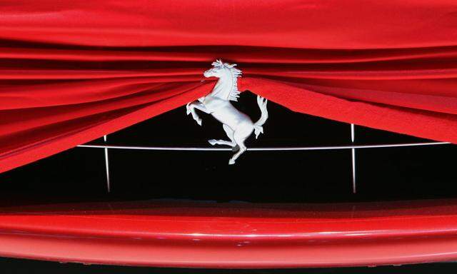 A cover is pictured on Ferrari car on the booth during a preview day of the upcoming 80th Geneva Car Show at the Palexpo in Geneva