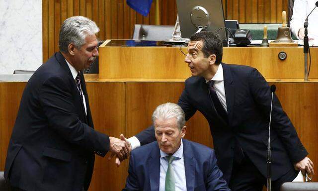 Austria´s Chancellor Kern shakes hands with Finance Minister Schelling behind Vice Chancellor Mitterlehner as they arrive in the parliament in Vienna