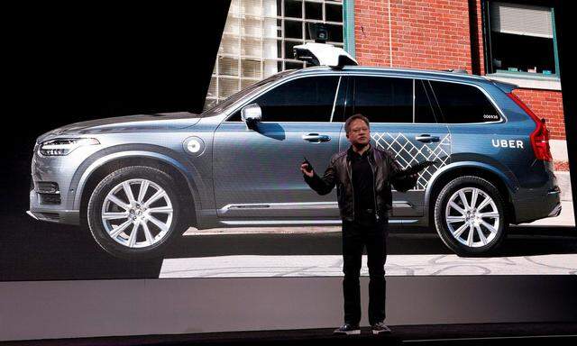 FILE PHOTO: Jensen Huang, CEO of Nvidia, announces that Nvidia and Uber will partner to build self-driving cars during his keynote address at CES in Las Vegas