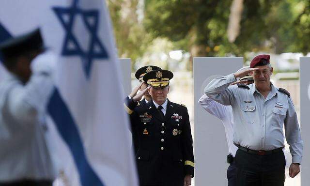 U.S. Chairman of the Joint Chiefs of Staff, General Dempsey and Israel's armed forces chief Major-General Gantz salute during an honour guard ceremony at the Defence Ministry in Tel Aviv