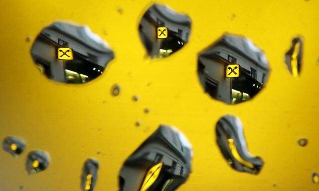 File photo of the logo of Raiffeisen bank as seen through raindrops at a branch office in Vienna