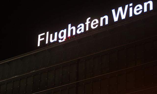 The illuminated sign of ´Flughafen Wien´ (Airport Vienna) is pictured atop an office building at the Vienna International Airport in Schwechat