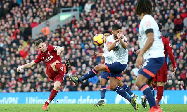 James Milner L of Liverpool shoots during the Premier League match at Anfield Stadium Liverpool