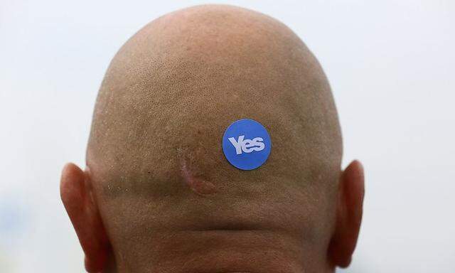 A 'Yes' sticker is seen on the back of a man's head at a pro-independence rally in Glasgow, Scotland