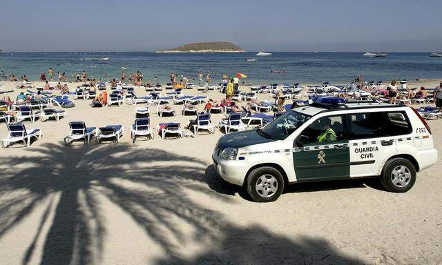 Civil guards patrol along Magalluf beach in Mallorca